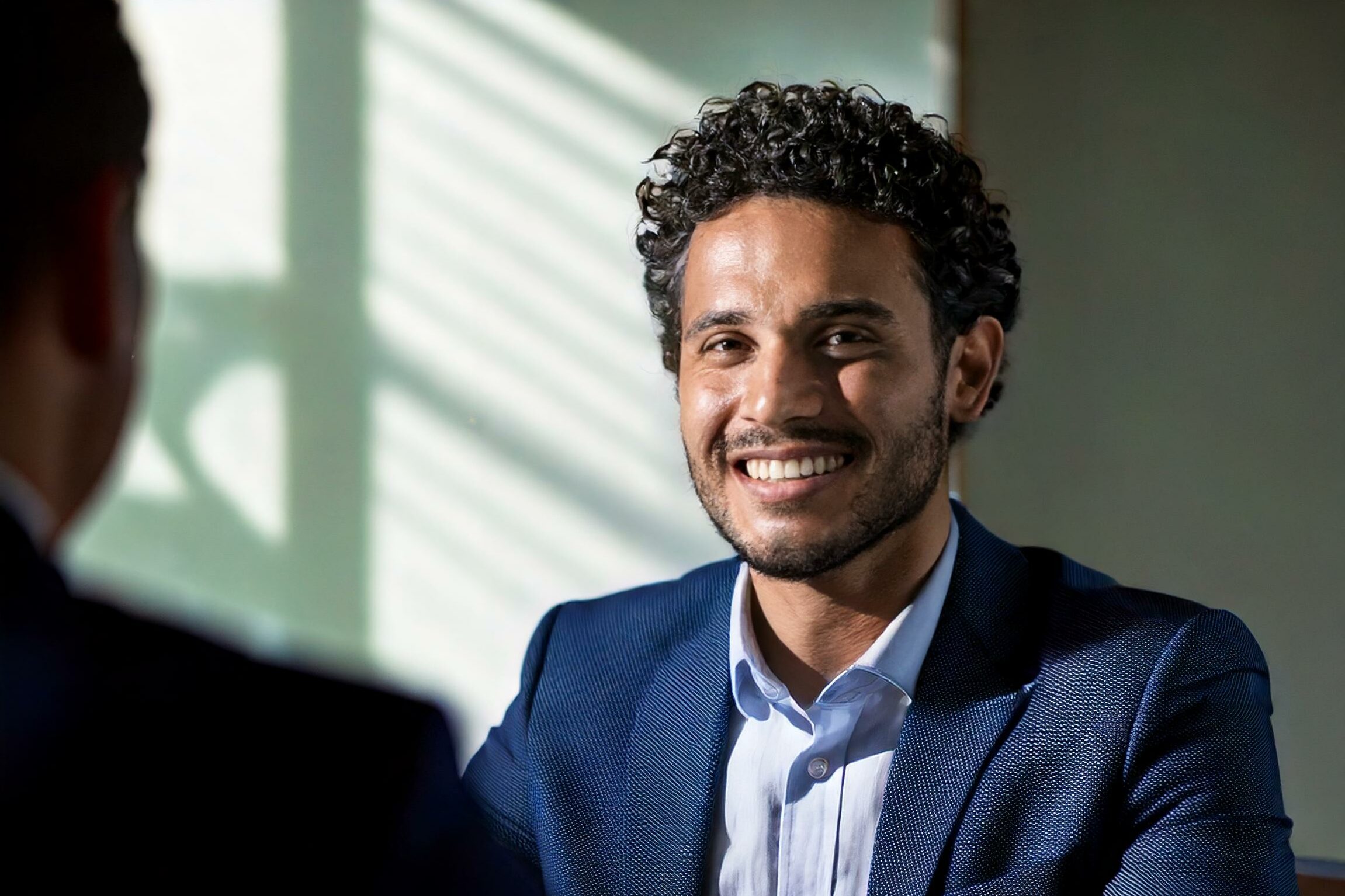 Hr Manager Smiling At Candidate While Conducting An Interview. Natural Light With A Soft Fill Light To Reduce Shadows. Professional And Calm Atmosphere